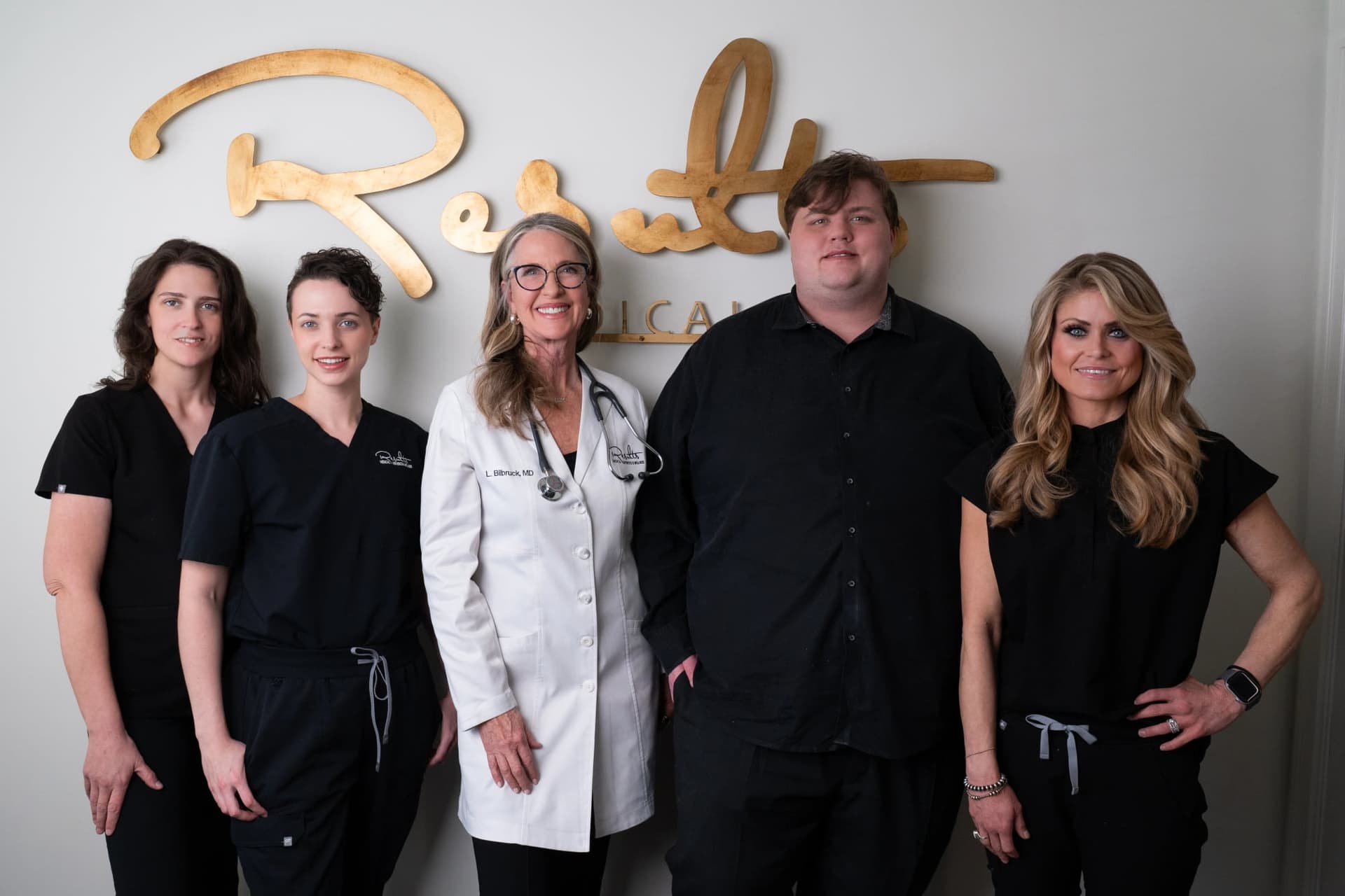 Physician and four Results Medical Aesthetics staff members, group portrait