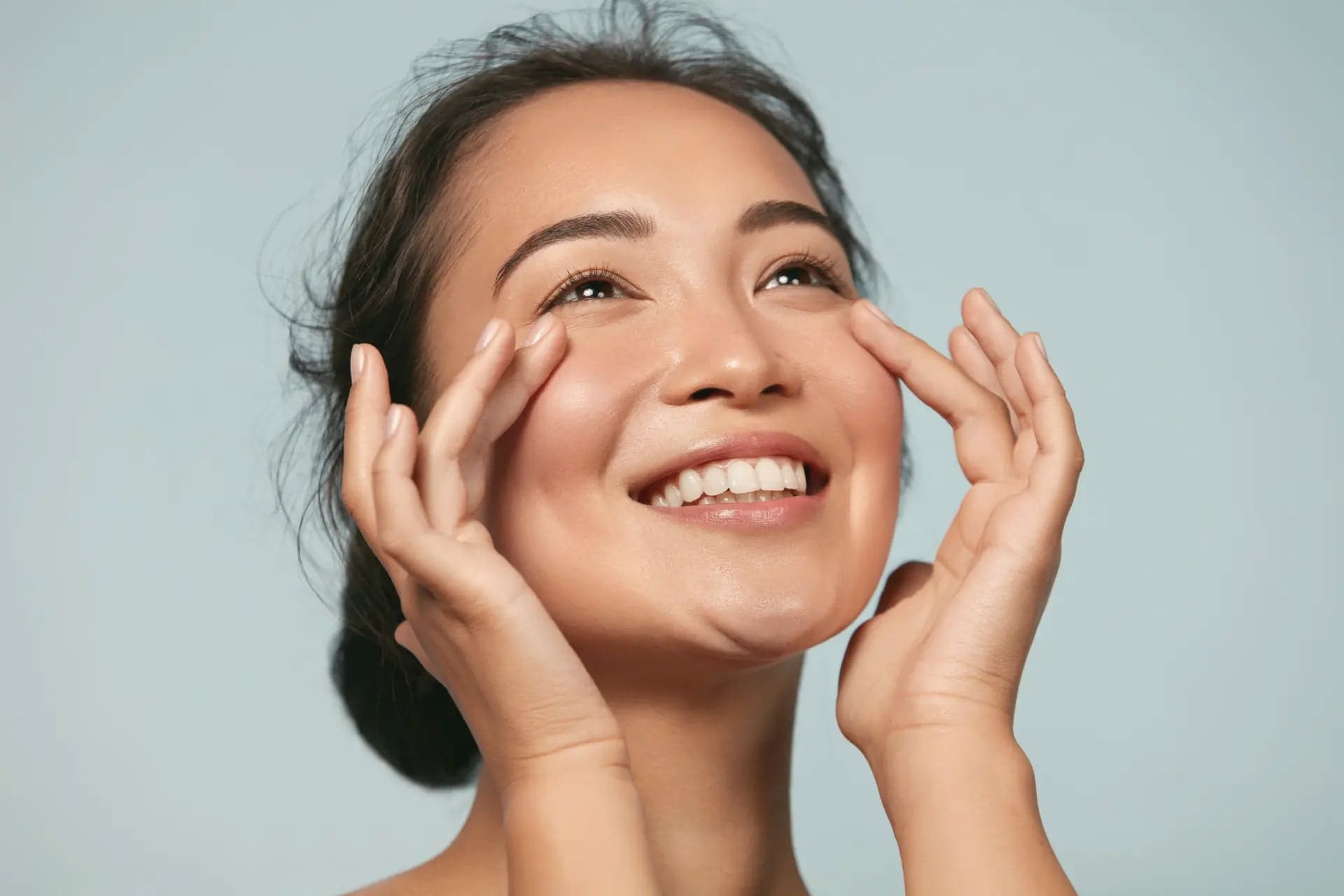 Close-up beauty portrait of a woman touching her face