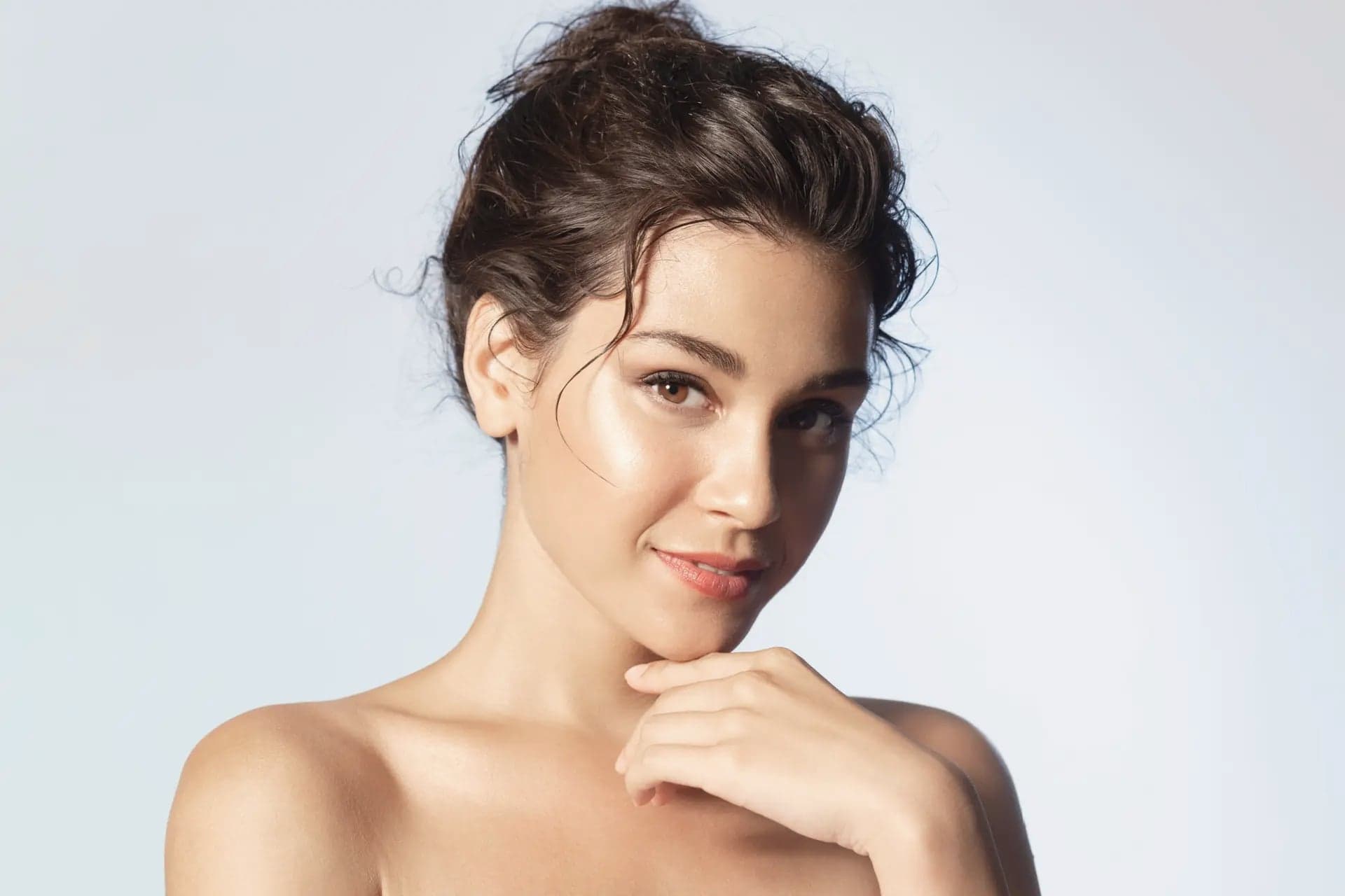 Close-up beauty portrait of a woman with a wet-look updo